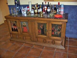 Old spine Spanish colonial cabinet with frieze of painted panel. This cabinet had to be stripped, stained and refinished with a satin hand-rubbed lacquer. The painted panels has to be cleaned and restored.